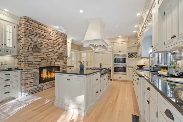 a large white kitchen with cabinets