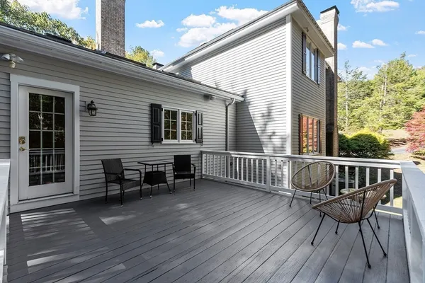 a view of a chair and table on the wooden deck