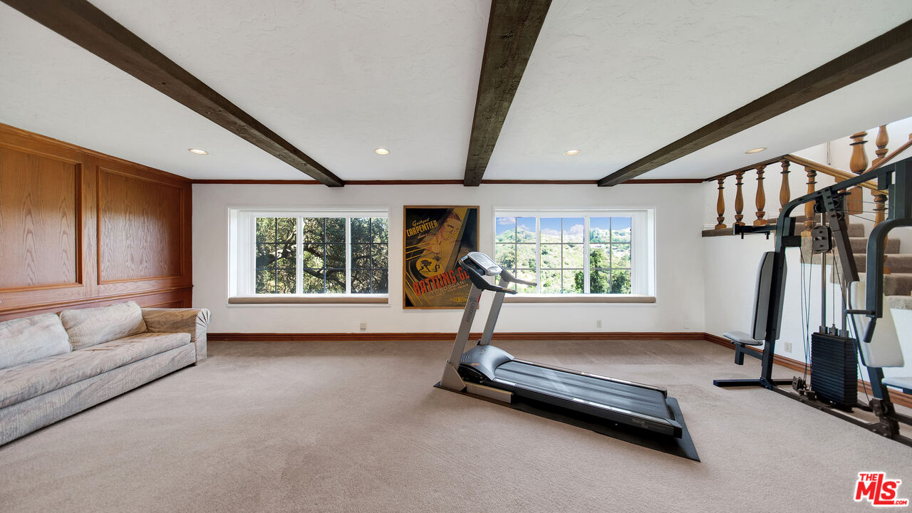 2312 Kimridge Road Beverly Hills, CA 90210 - Photo 45 of 60 a living room with gym equipment and a large window