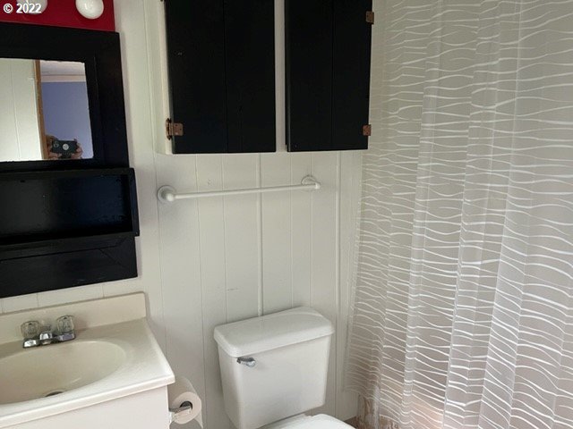 88148 5th Street Veneta, OR 97487 - Photo 15 of 20 a bathroom with a toilet a sink and mirror