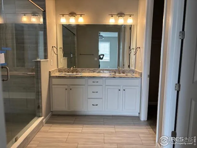 a bathroom with a double vanity sink and mirror