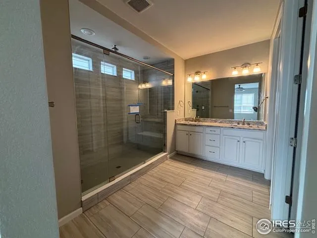 a bathroom with a mirror and a shower