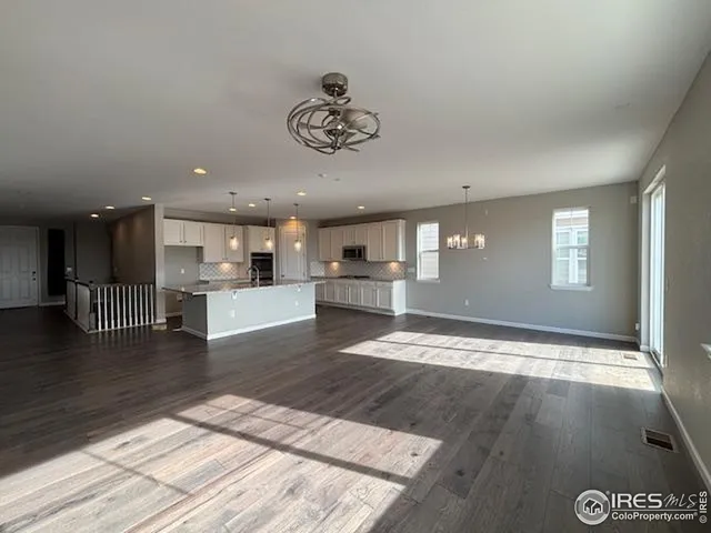 a view of kitchen and hall with wooden floor