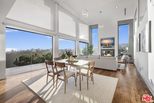a dining room with furniture wooden floor and a rug