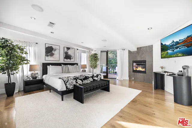 a living room with furniture flat screen tv and a fireplace