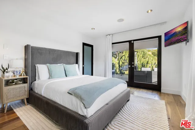 a bedroom with a large bed and a large window