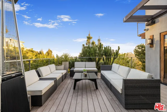a sitting area with furniture and wooden floor