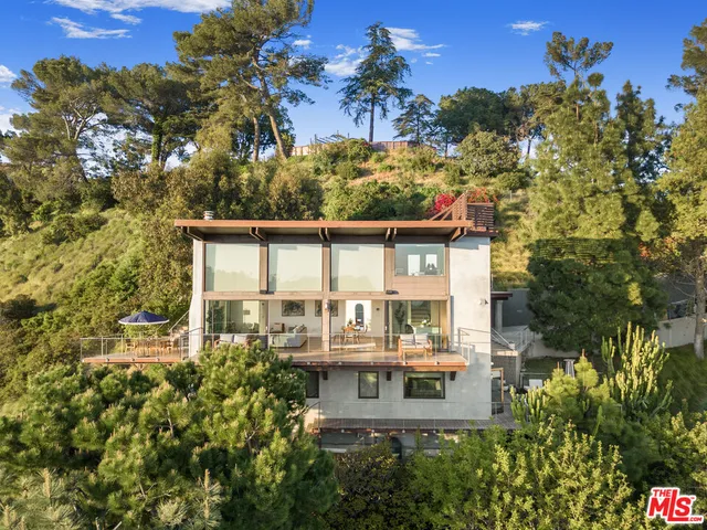 a view of a house with a yard and balcony
