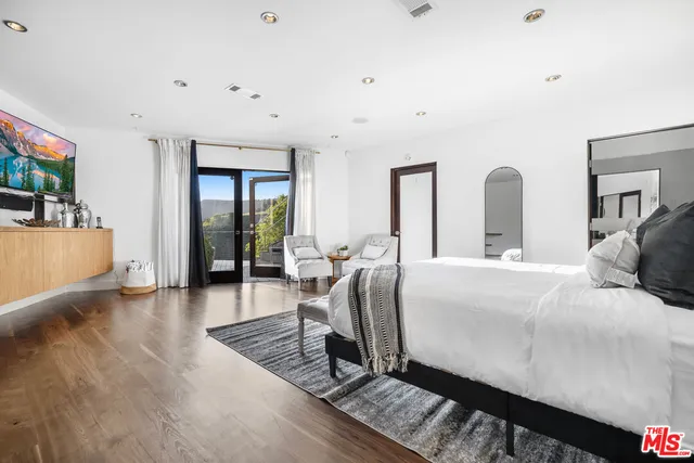 a bathroom with a bathtub sink mirror vanity and toilet