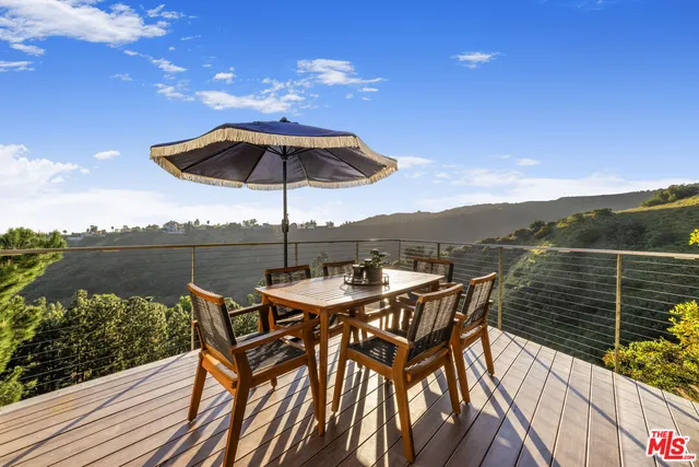 an outdoor space with furniture and umbrella