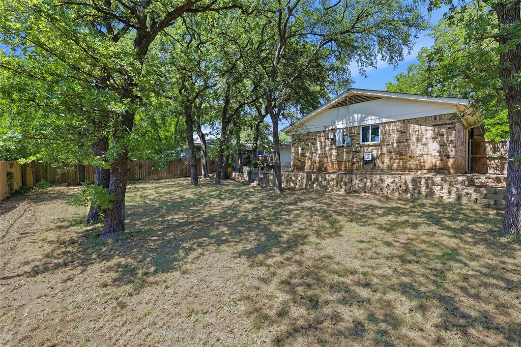 16 Coffee Tavern Road Bedford, TX 76022 - Photo 22 of 24 Expansive lawn area featuring numerous mature trees providing ample shade