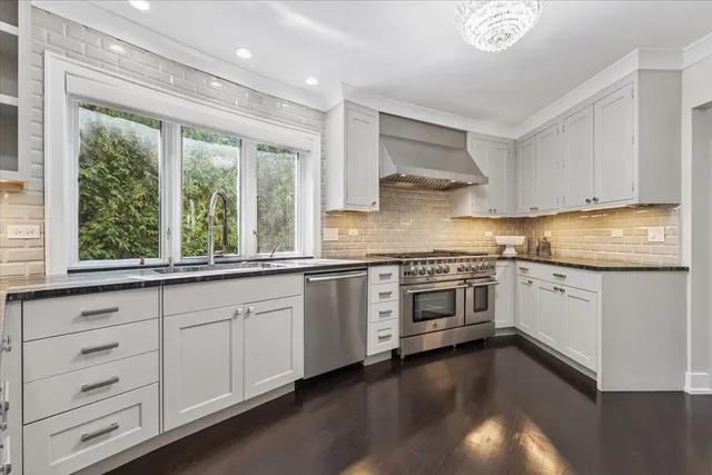 a living room with furniture wooden floor and a large window