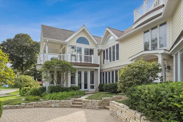 a view of a white house next to a yard