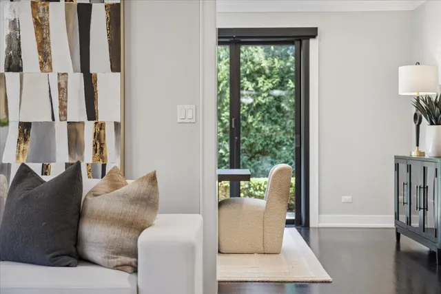 a living room with furniture and a floor to ceiling window