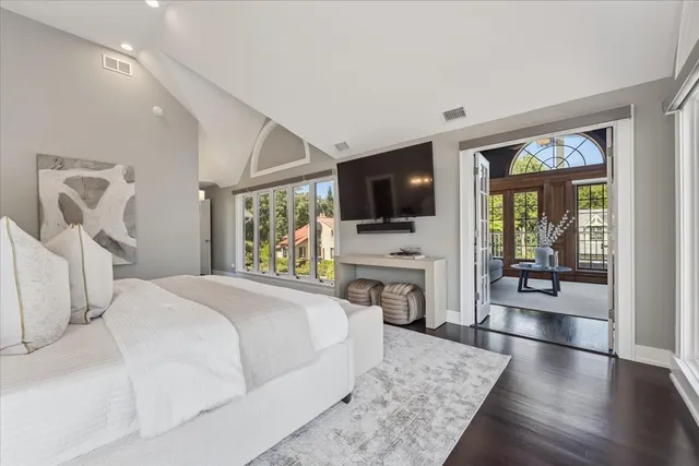a view of an empty room with wooden floor and closet area