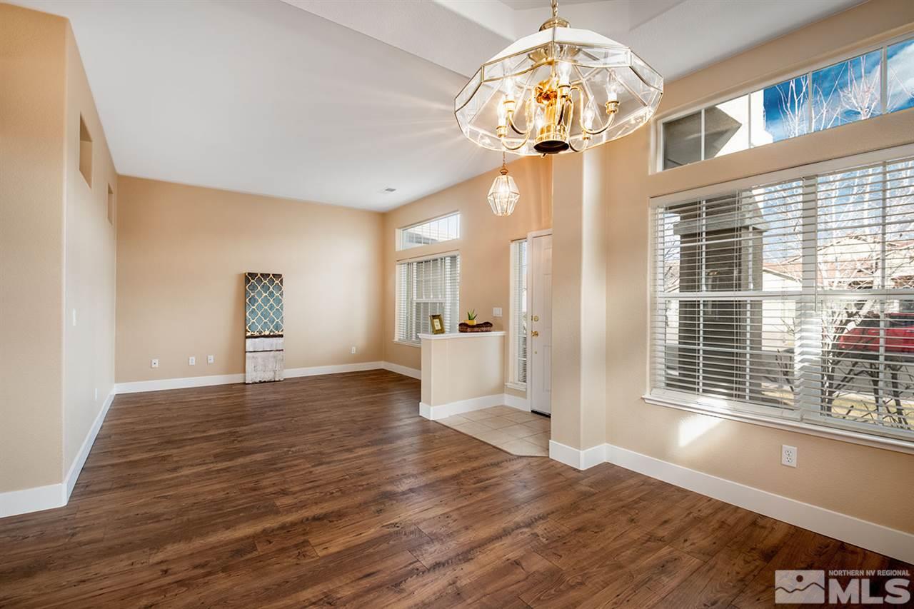1726 Colavita Way Reno, NV 89521 - Photo 3 of 23 a view of an empty room with wooden floor and a window