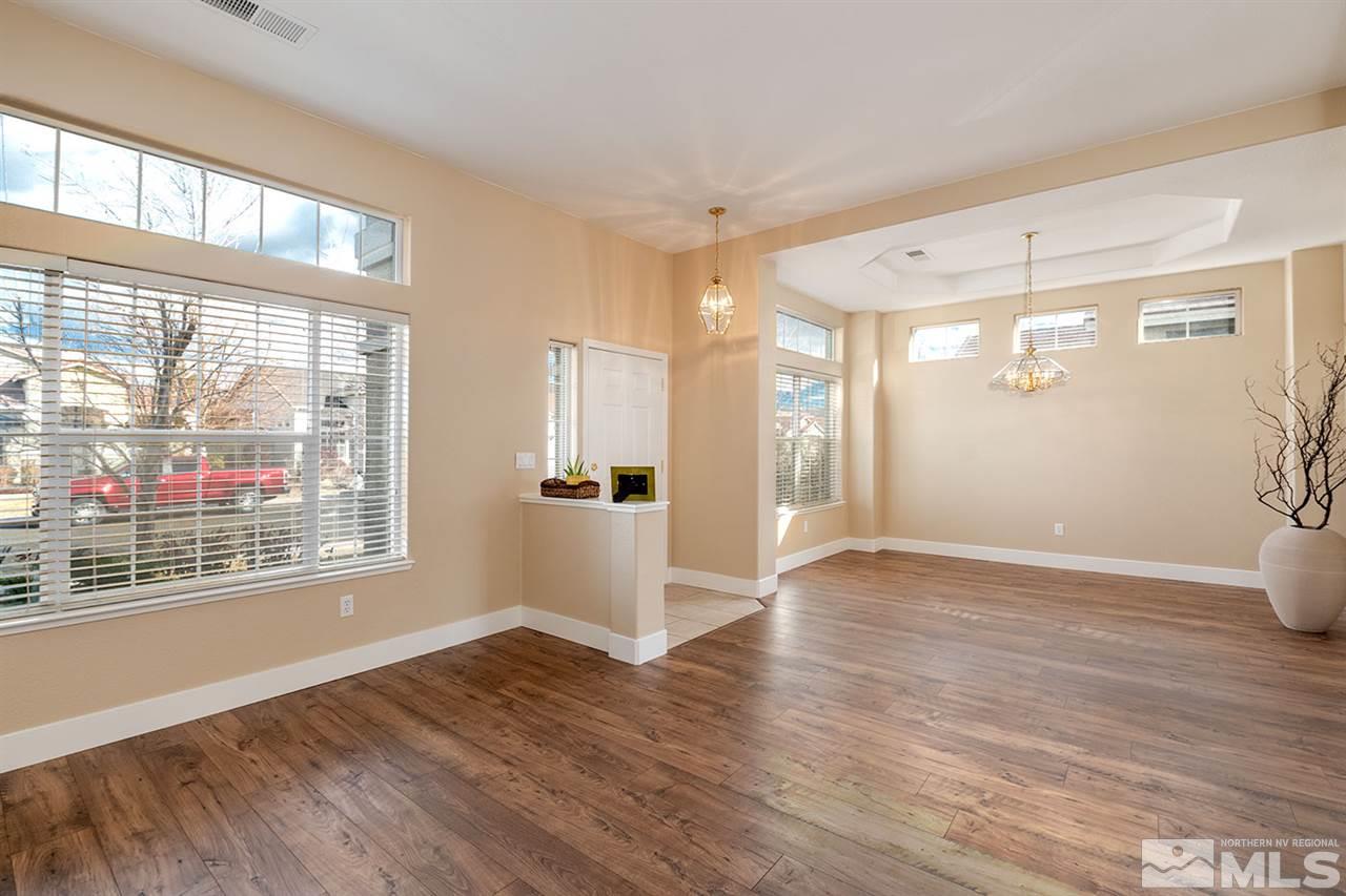 1726 Colavita Way Reno, NV 89521 - Photo 4 of 23 a view of an empty room with wooden floor and a window