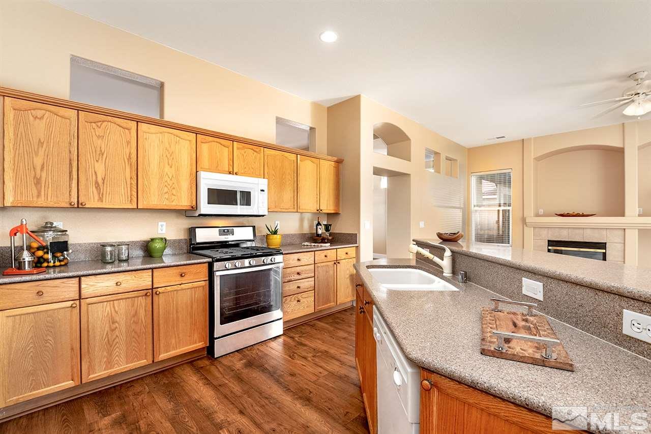 1726 Colavita Way Reno, NV 89521 - Photo 10 of 23 a kitchen with stainless steel appliances granite countertop a sink a stove and cabinets