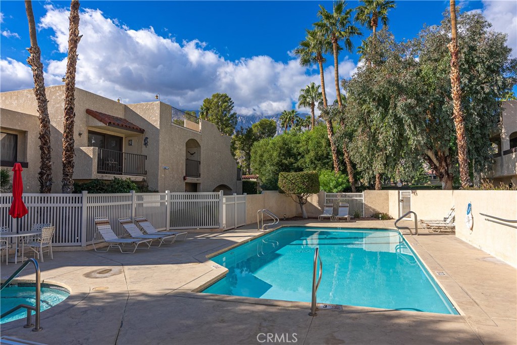 200 East Racquet Club Road, Unit 24 Palm Springs, CA 92262 - Photo 15 of 21 a swimming pool with outdoor seating and yard