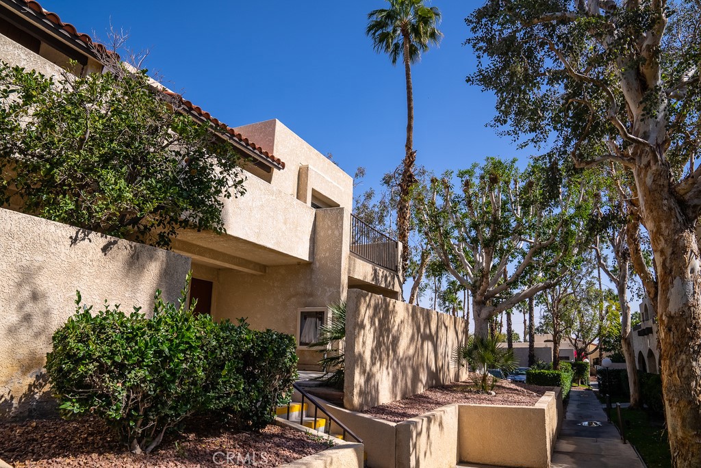 200 East Racquet Club Road, Unit 24 Palm Springs, CA 92262 - Photo 19 of 21 a view of a patio with couches and potted plants