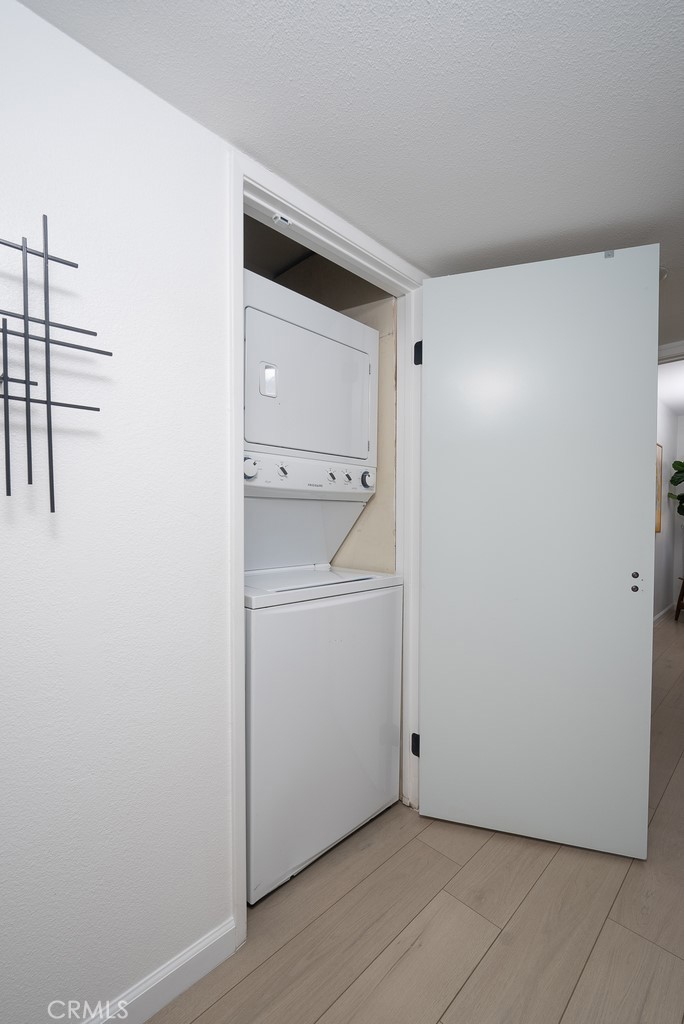 200 East Racquet Club Road, Unit 24 Palm Springs, CA 92262 - Photo 5 of 21 a view of storage and utility room with washer and dryer