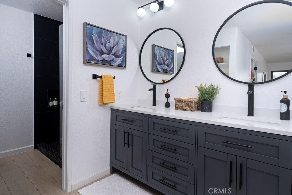 200 East Racquet Club Road, Unit 24 Palm Springs, CA 92262 - Photo 7 of 21 a bathroom with a two sinks and a mirror