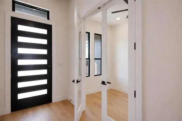 a view of a hallway with wooden floor