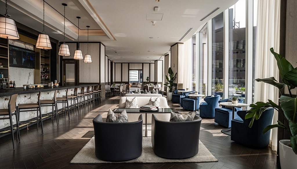 240 Devonshire Street, Unit 5514 Boston, MA 02110 - Photo 13 of 26 a living room with furniture and a large window