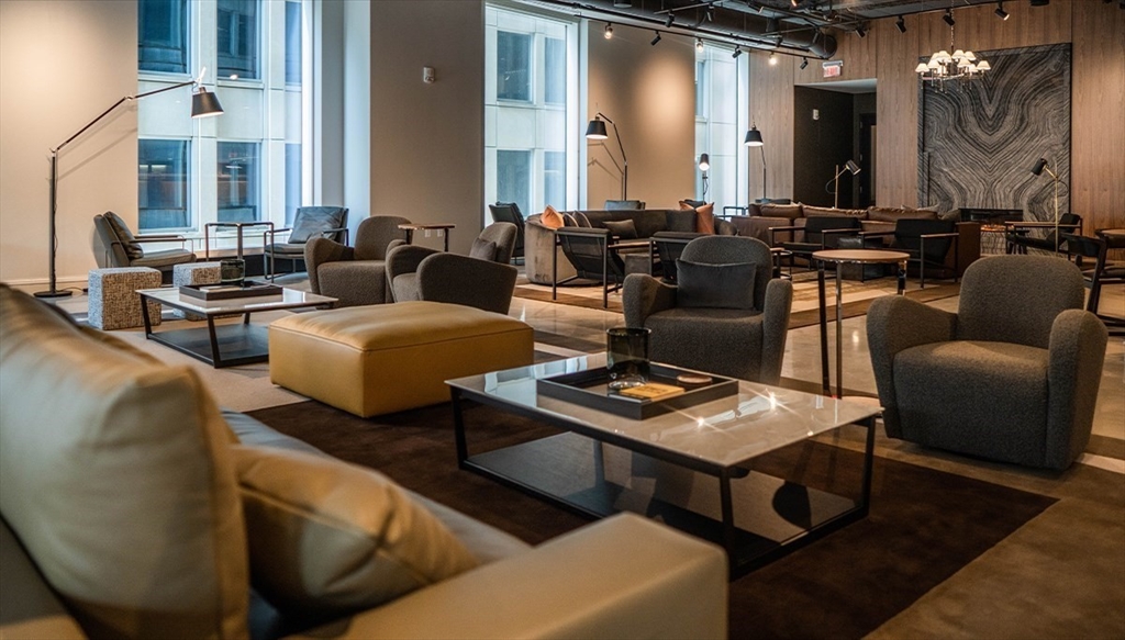 240 Devonshire Street, Unit 5514 Boston, MA 02110 - Photo 23 of 26 a living room with furniture and wooden floor