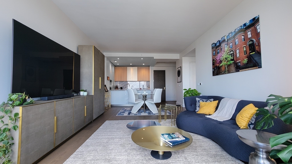 240 Devonshire Street, Unit 5514 Boston, MA 02110 - Photo 7 of 26 a living room with furniture and a flat screen tv
