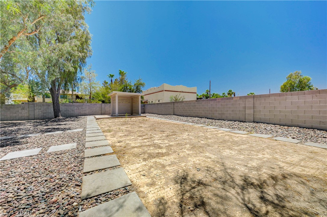 7631 Bermuda Road Las Vegas, NV 89123 - Photo 43 of 64 A spacious backyard with a simple pergola offers ample space for future outdoor living designs.