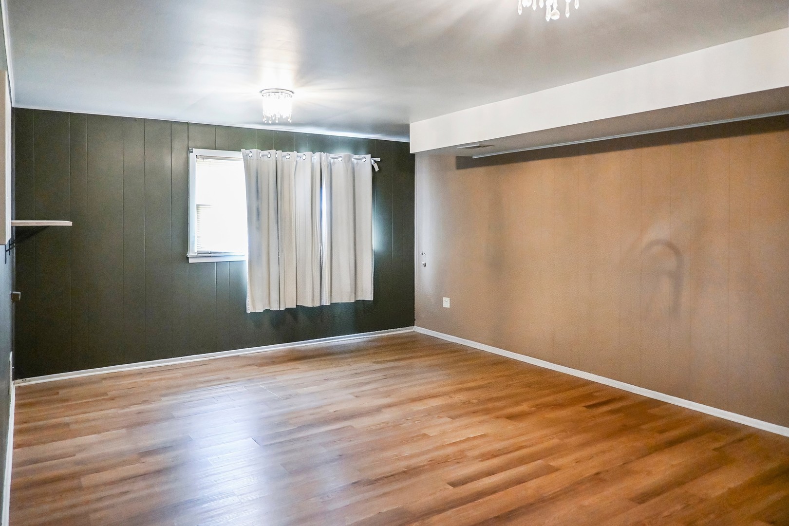 15115 Springfield Avenue Midlothian, IL 60445 - Photo 15 of 18 wooden floor in an empty room with a window