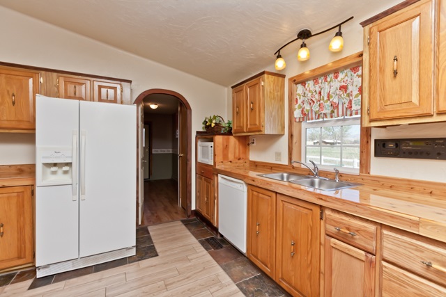 890-20 20 1/2 Road Fruita, CO 81521 - Photo 11 of 37 a kitchen with stainless steel appliances granite countertop a refrigerator a stove and a sink with large window