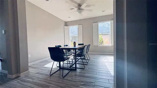 a view of a dining room with furniture and wooden floor