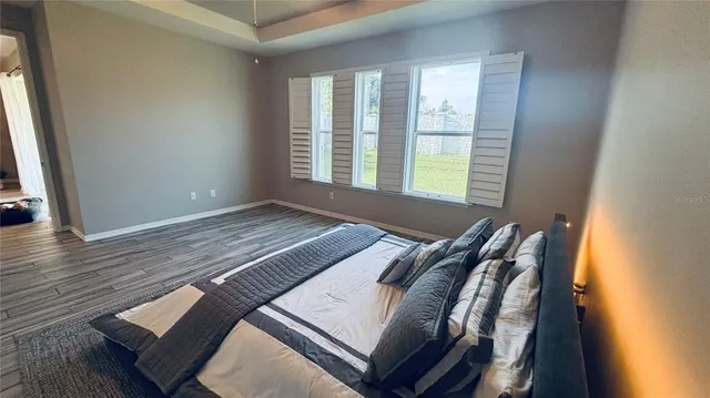 a bed sitting in a bedroom next to a window