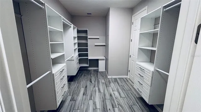 a view of walk in closet with empty racks