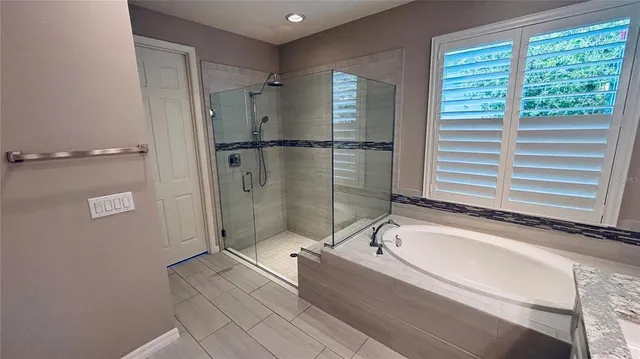 a bathroom with a bathtub and a shower