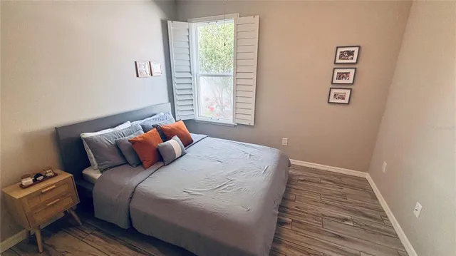 a bedroom with a bed and a window