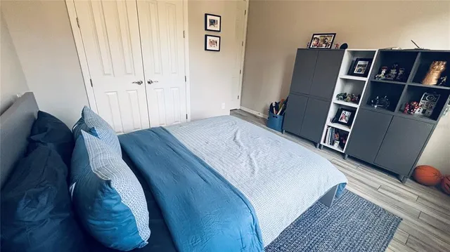 a bed room with a bed and a book shelf