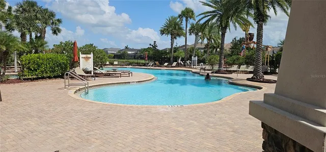 a view of a swimming pool with chairs