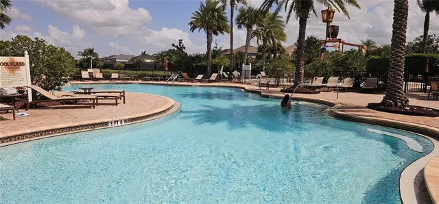 a view of a swimming pool with lounge chairs