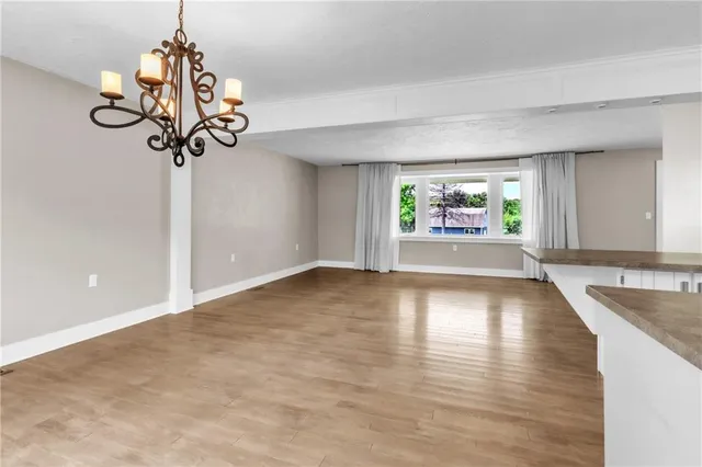 a view of a room with a window and chandelier