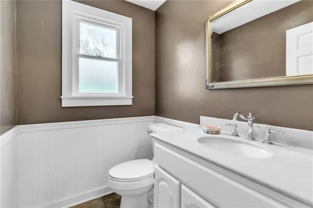 a bathroom with a sink toilet and mirror