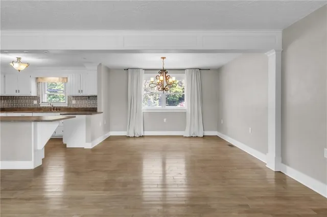 a view of a kitchen with wooden floor and a kitchen