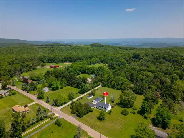an aerial view of residential house with pool garden and outdoor seating