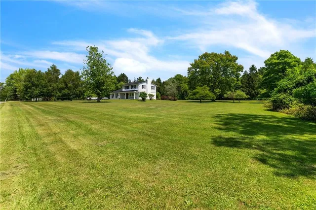 a view of a field with an trees in the background