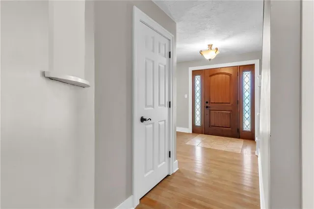 a view of a hallway with wooden floor