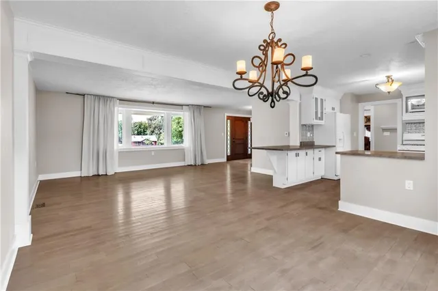 a view of a living room and kitchen with a window