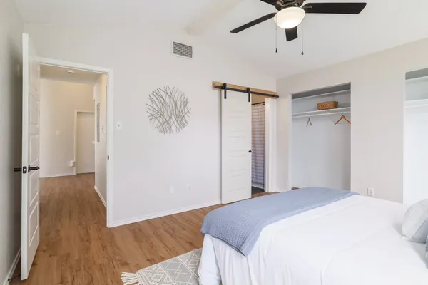 a bedroom with a bed and a chandelier