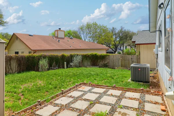 a view of a backyard with potted plants and a fountain